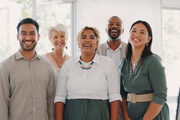 Collaboration, motivation and mindset with a business team posing for a photograph together in the office. Happy, smile and teamwork with a man and woman employee taking a picture while at work.